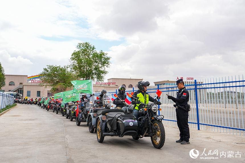 二連出入境邊防檢查站移民管理警察查驗摩托車自駕旅游團成員通關證件。楊金燁攝