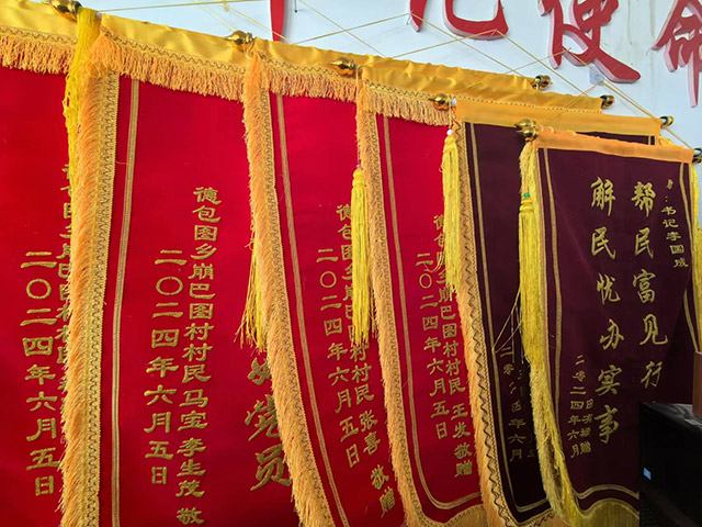 圖為崩巴圖村民送來的一幅幅錦旗。記者 張棖攝